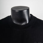 Black crew-neck T-shirt collar close-up on mannequin.