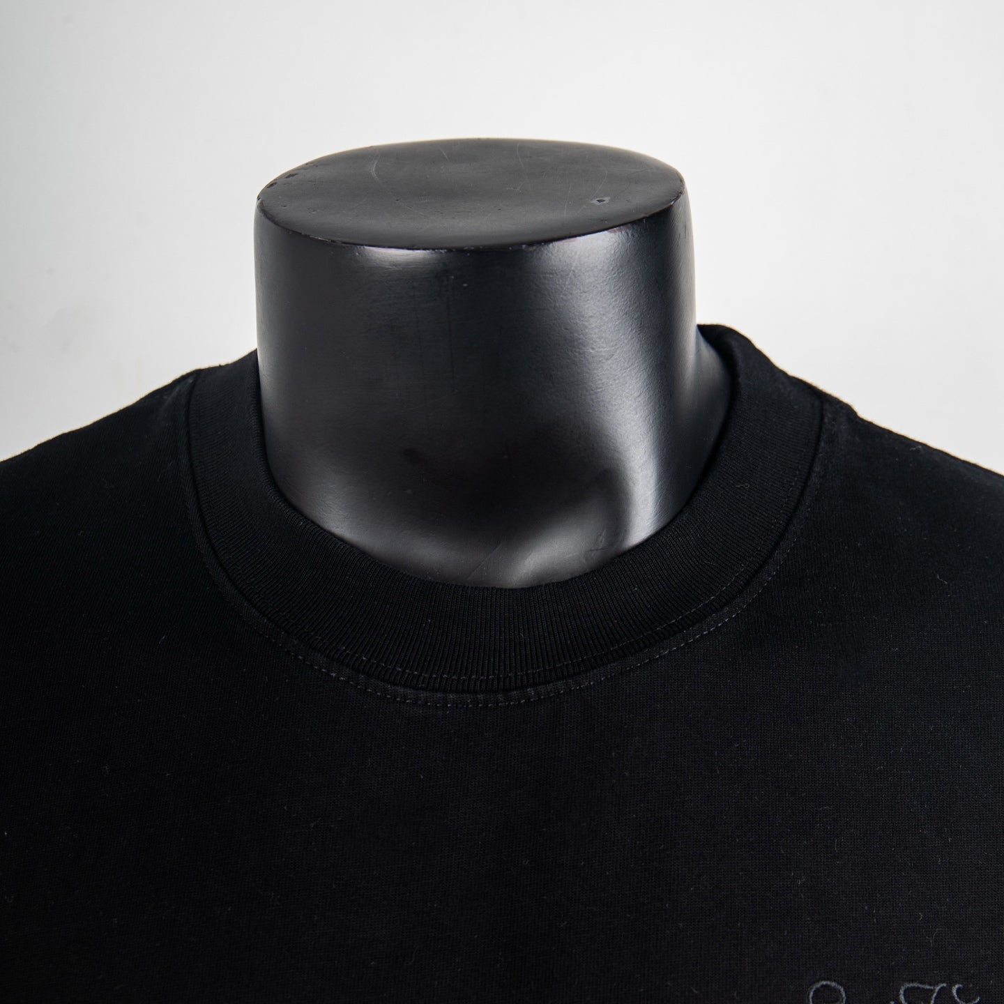 Louis Vuitton black crew-neck T-shirt neckline and collar seam on a mannequin