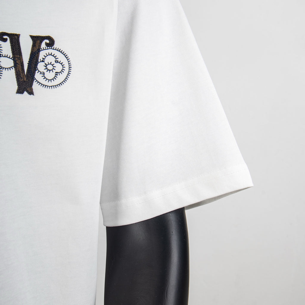 White T-shirt sleeve and side hem with partial 'LV' logo visible