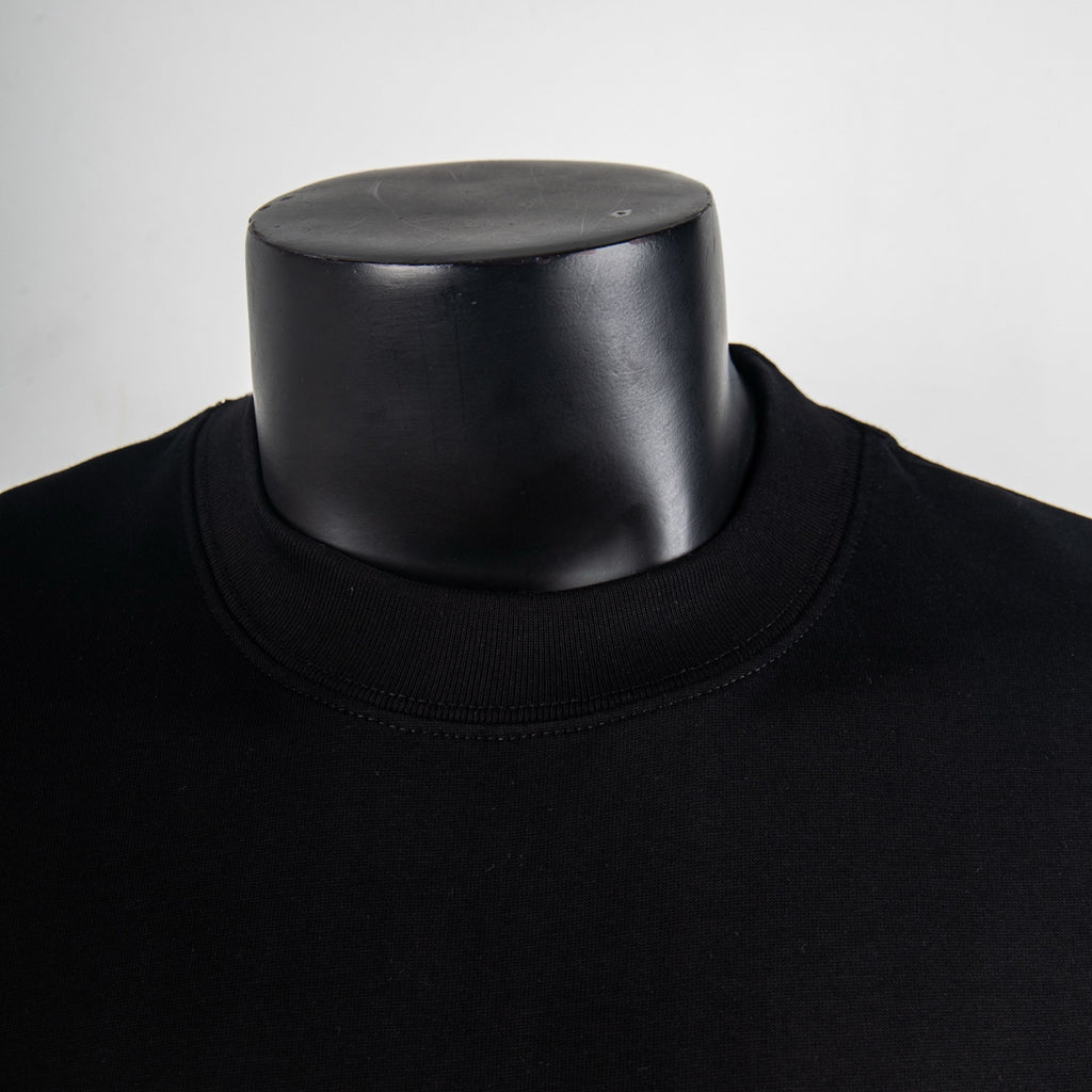 Black crewneck T-shirt collar close-up with ribbed neckline