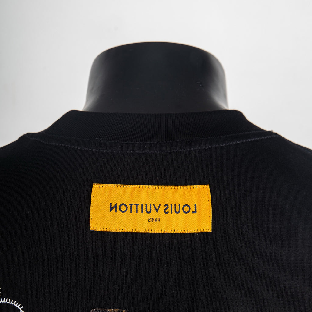 Black T-shirt neck label in yellow on ribbed crew collar