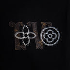 Black T-shirt front close-up of embroidered LV and Paris text