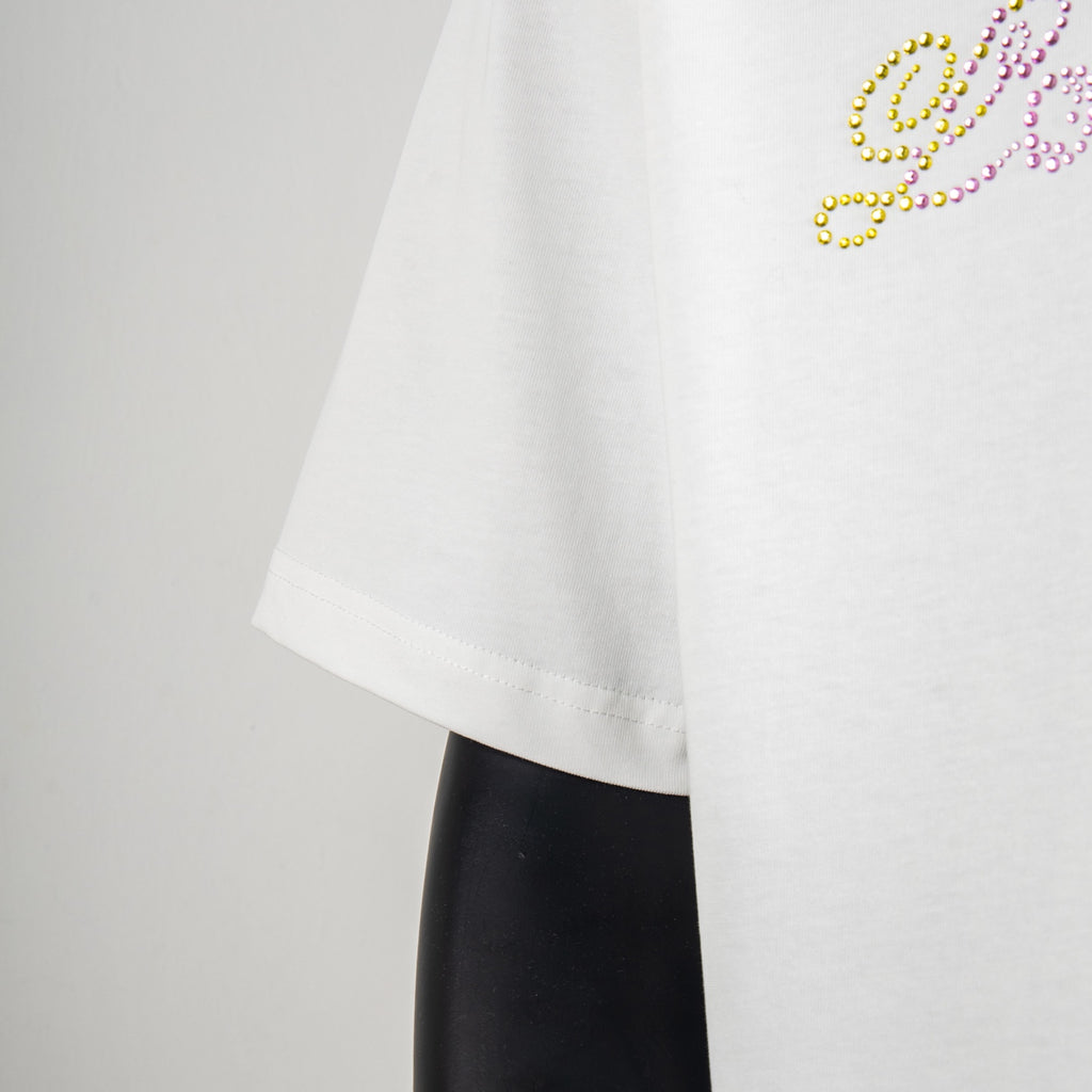 White T-shirt short sleeve with rhinestone lettering detail near hem.