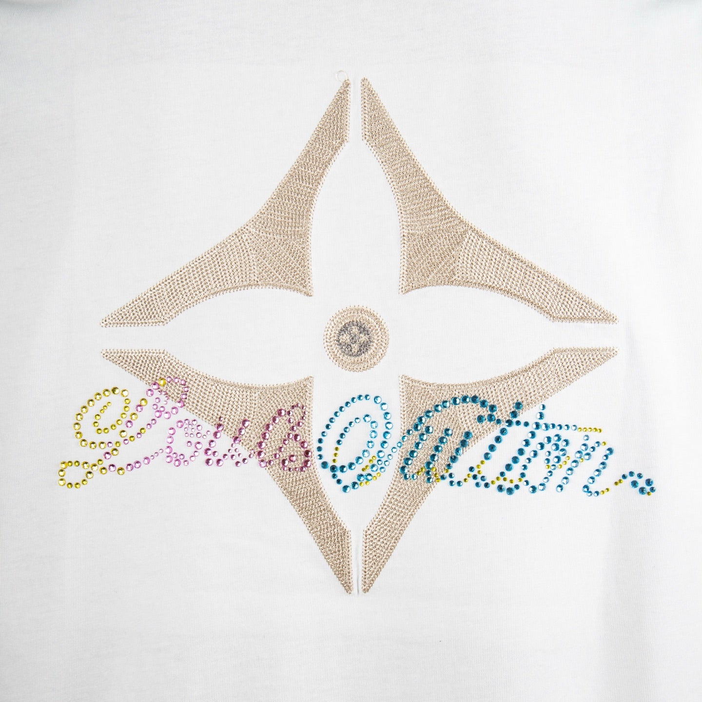 White T-shirt star-shaped rhinestone graphic with central snap detail.