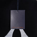 Black T-shirt with Louis Vuitton hang tag on blue string
