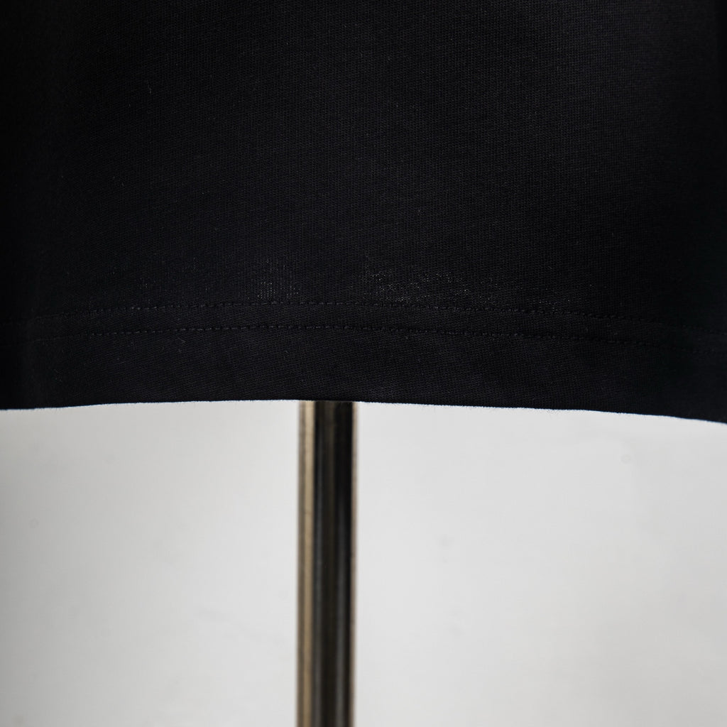 Black T-shirt hem with stitched seam close-up