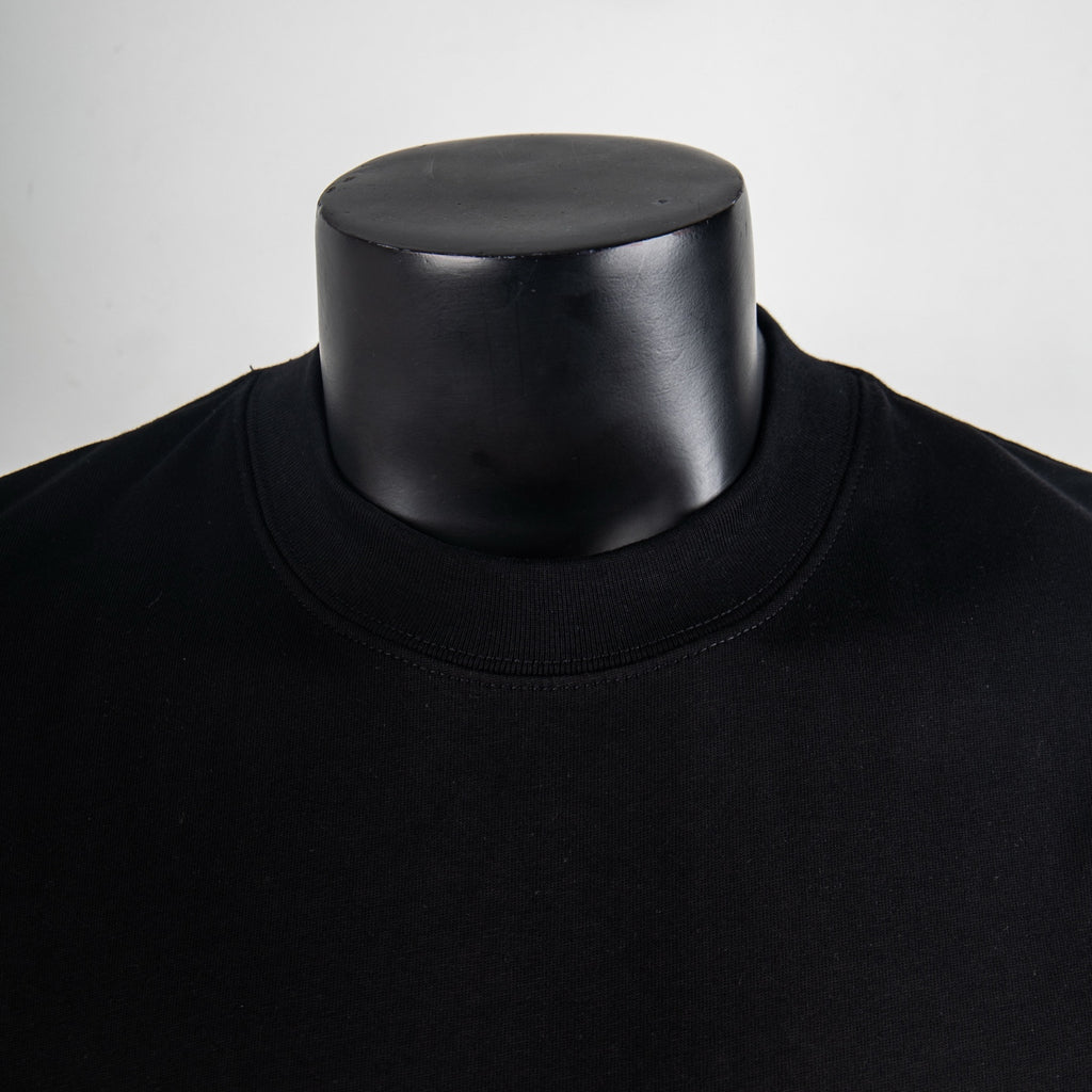 Black crew-neck T-shirt collar close-up