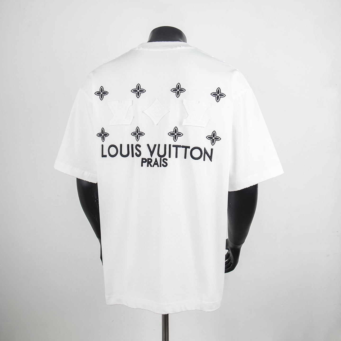 White crewneck T-shirt, back graphic with Louis Vuitton PRAIS lettering and emblems