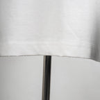White T-shirt lower hem with visible stitching detail