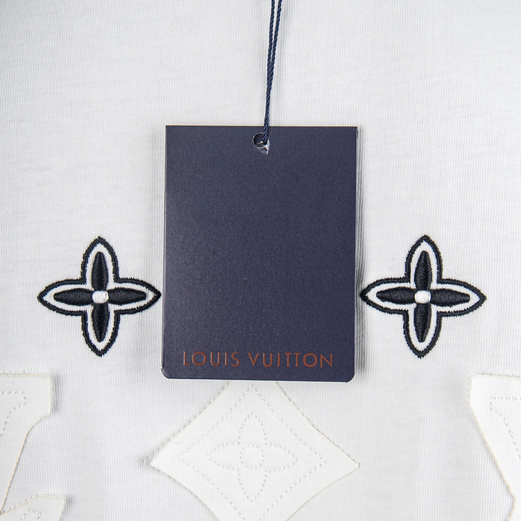 White T-shirt with hanging Louis Vuitton tag and navy monogram flower motifs