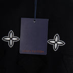 Black T-shirt with hang tag; cross motifs and Louis Vuitton Prais text