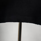 Black T-shirt hem with visible stitching