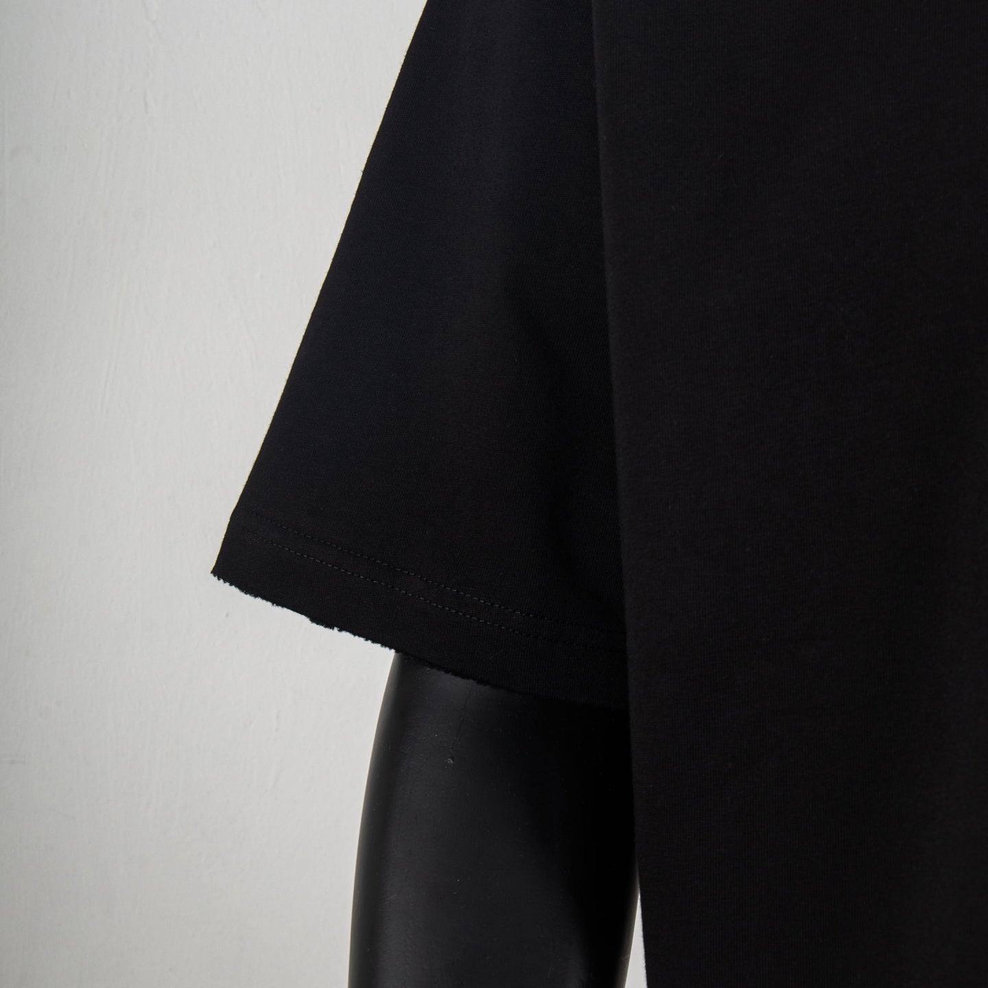 Black crew-neck short-sleeve T-shirt side view on mannequin