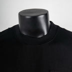 Black crew-neck short-sleeve T-shirt neckline close-up on mannequin