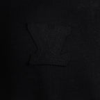 Black T-shirt chest area with embossed logo embroidery detail