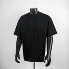 Black crew-neck short-sleeve T-shirt on mannequin, small chest logo detail