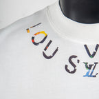 Louis Vuitton white T-shirt with large multicolor logo graphic at chest.