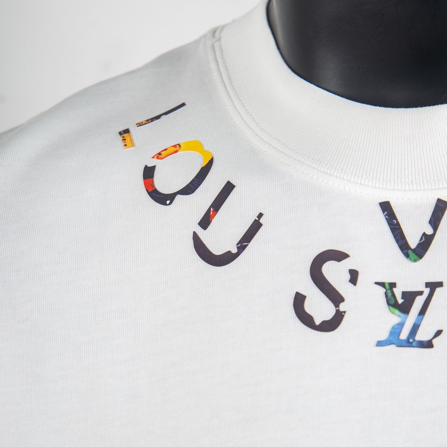 Louis Vuitton white T-shirt with large multicolor logo graphic at chest.