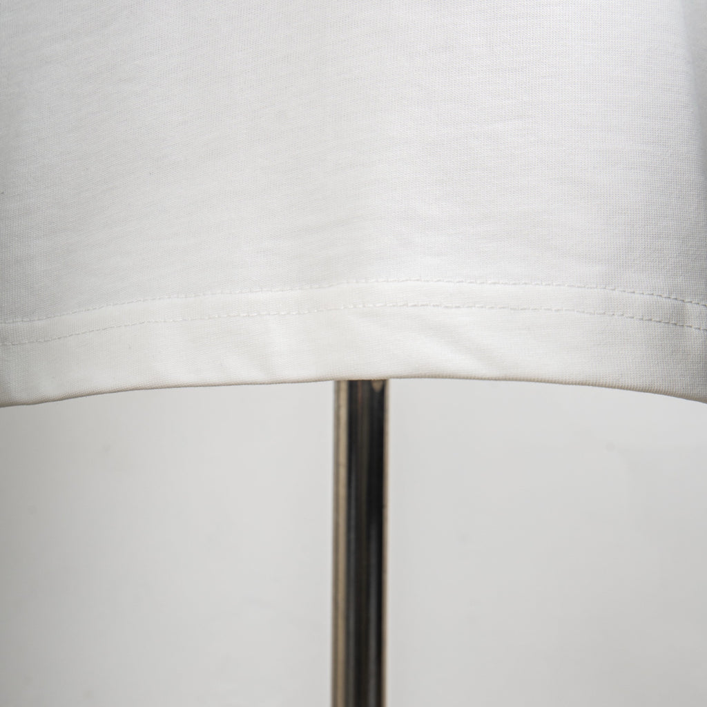 Louis Vuitton white T-shirt hem stitching seam detail.
