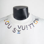 Louis Vuitton white T-shirt neckline with multicolor logo graphic detail.