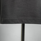 Dark gray T-shirt hem stitching along the bottom edge