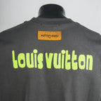 Dark gray T-shirt back with neon green Louis Vuitton text and neck tag