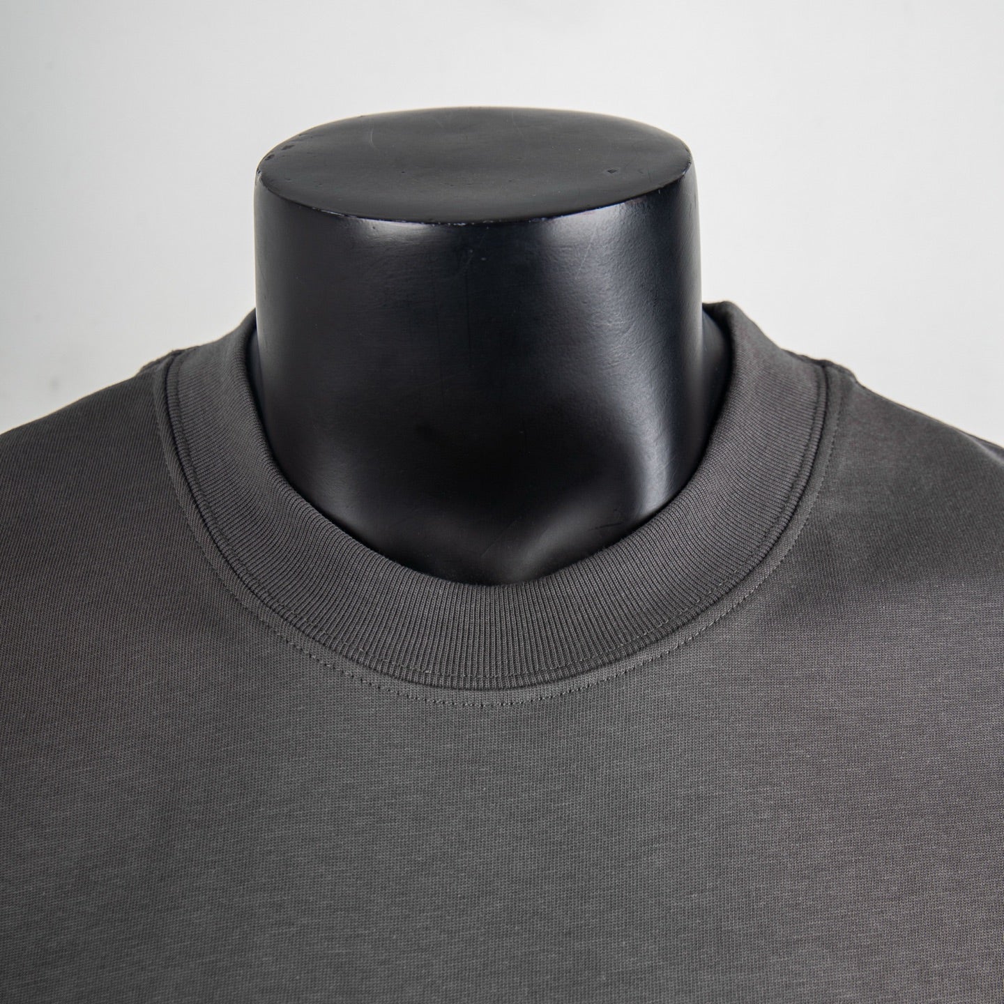Charcoal ribbed crew neckline of a short-sleeve T-shirt