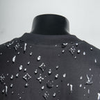 Black T-shirt with white logo pattern around back neckline