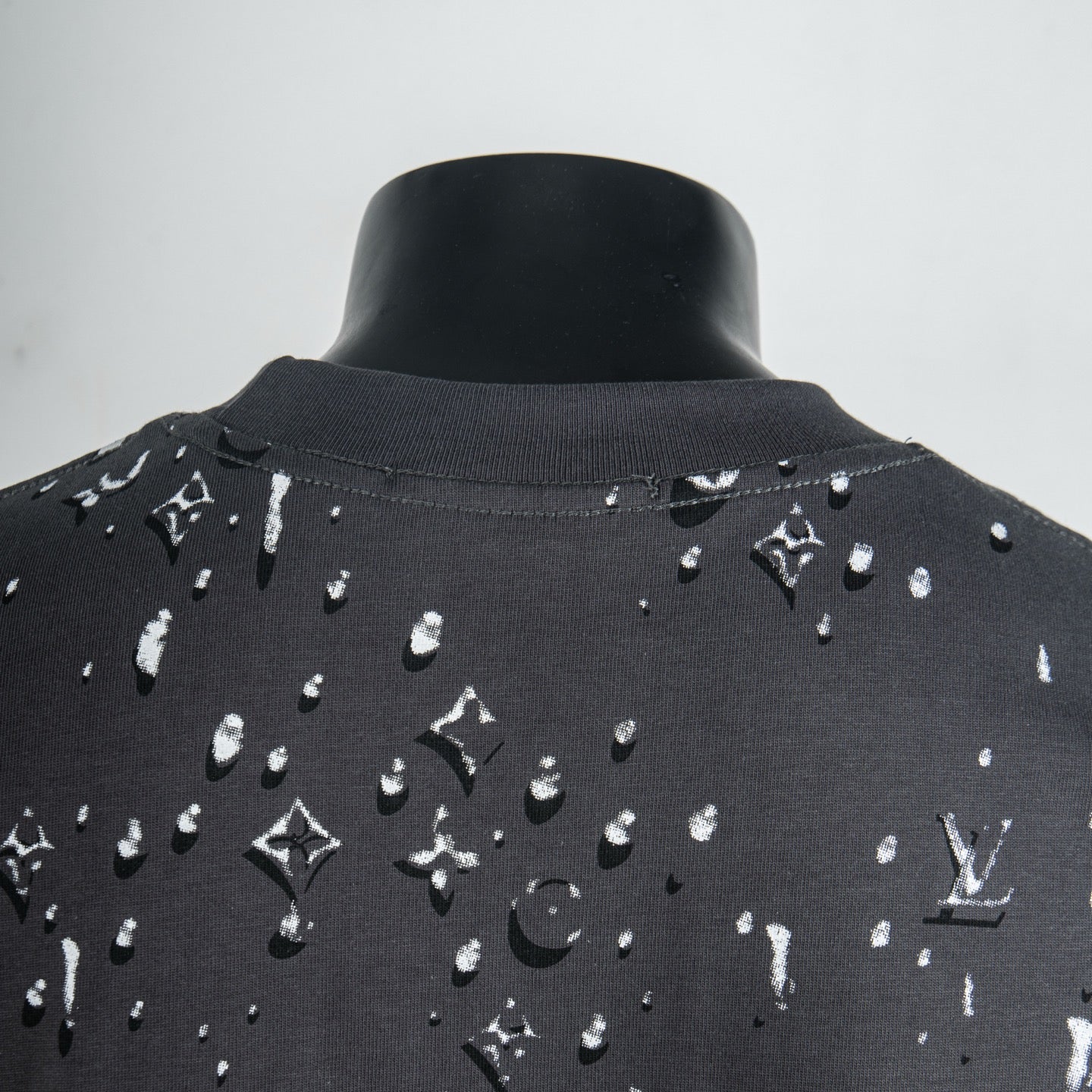 Black T-shirt with white logo pattern around back neckline