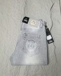 Light blue denim jeans with Versace waistband patch and front button fly