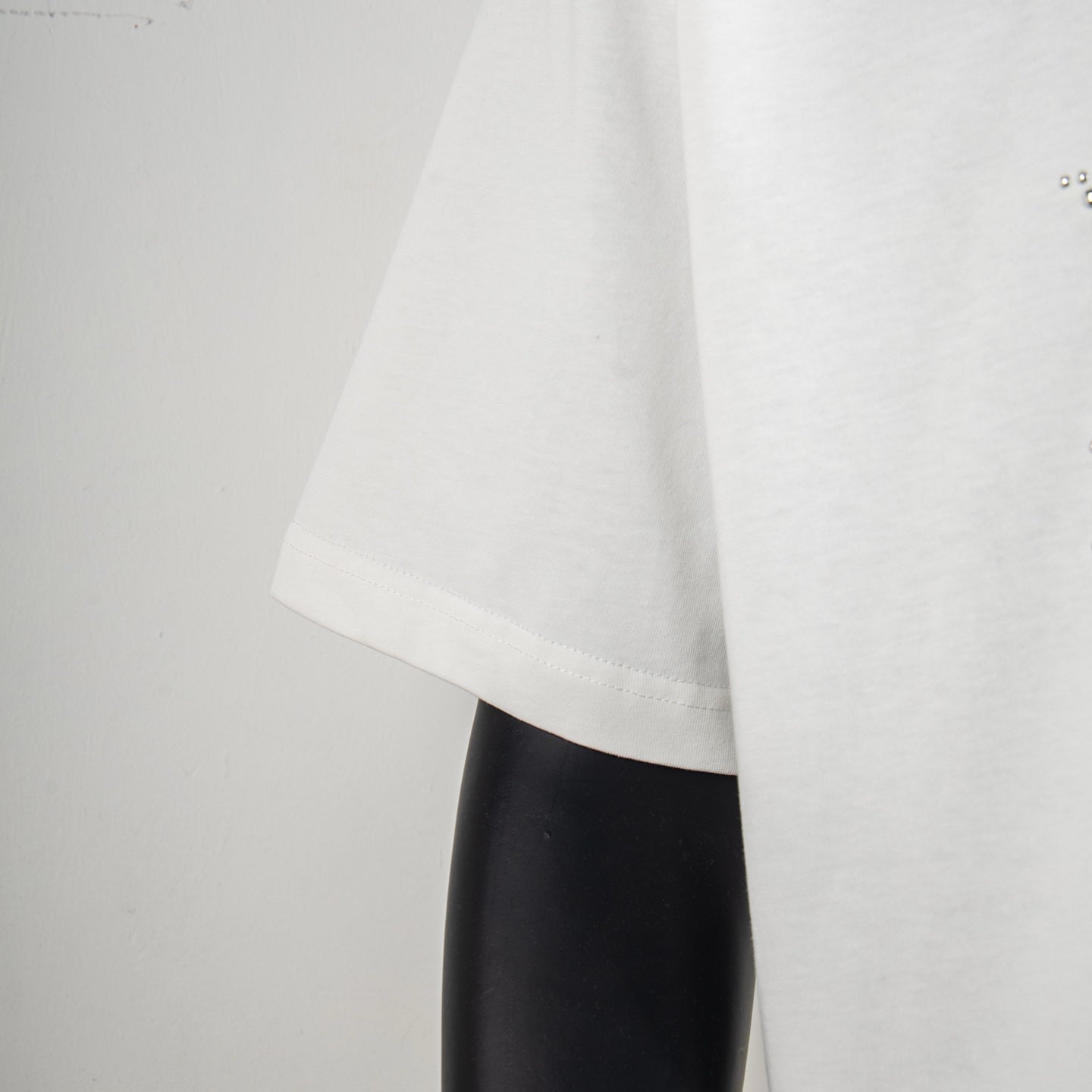White short-sleeve T-shirt side view showing drape and hem