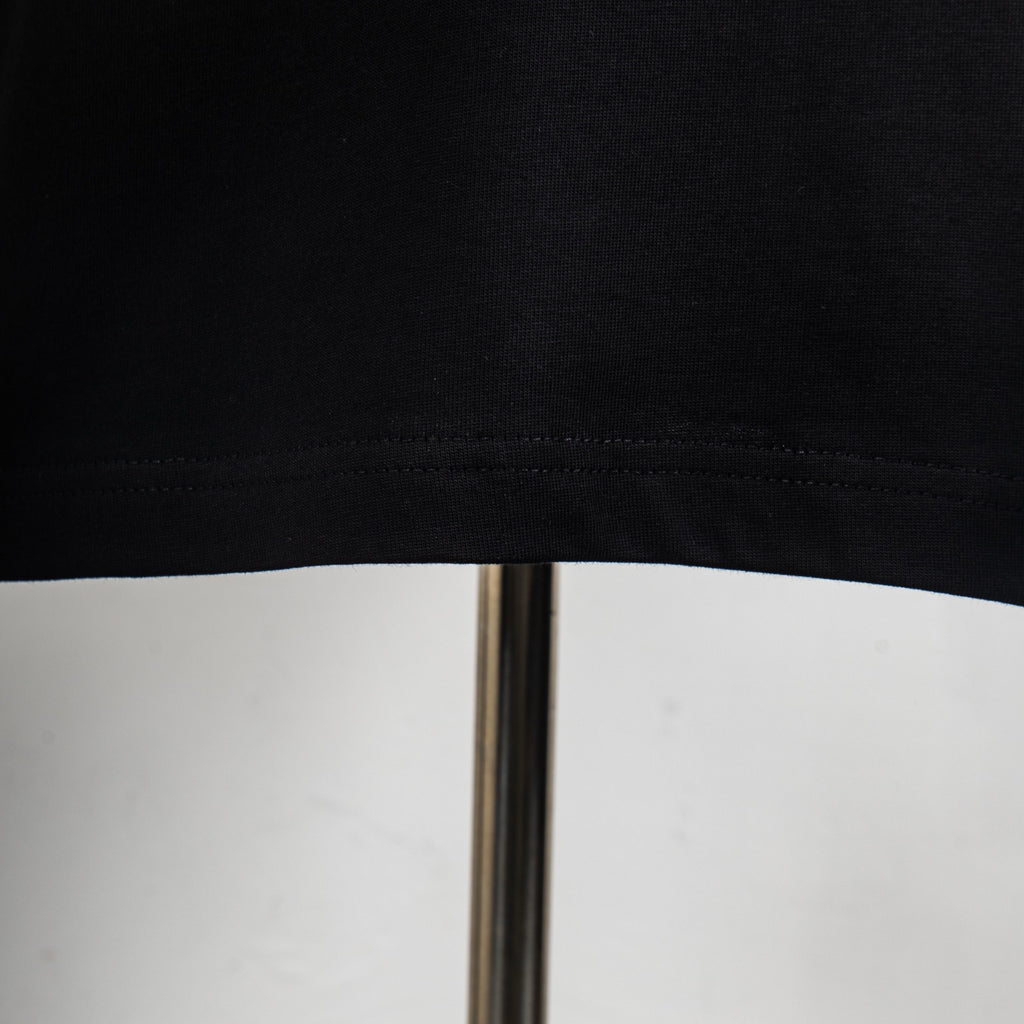 Black T-shirt hem and stitching close-up