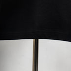 Black T-shirt hem and stitching close-up