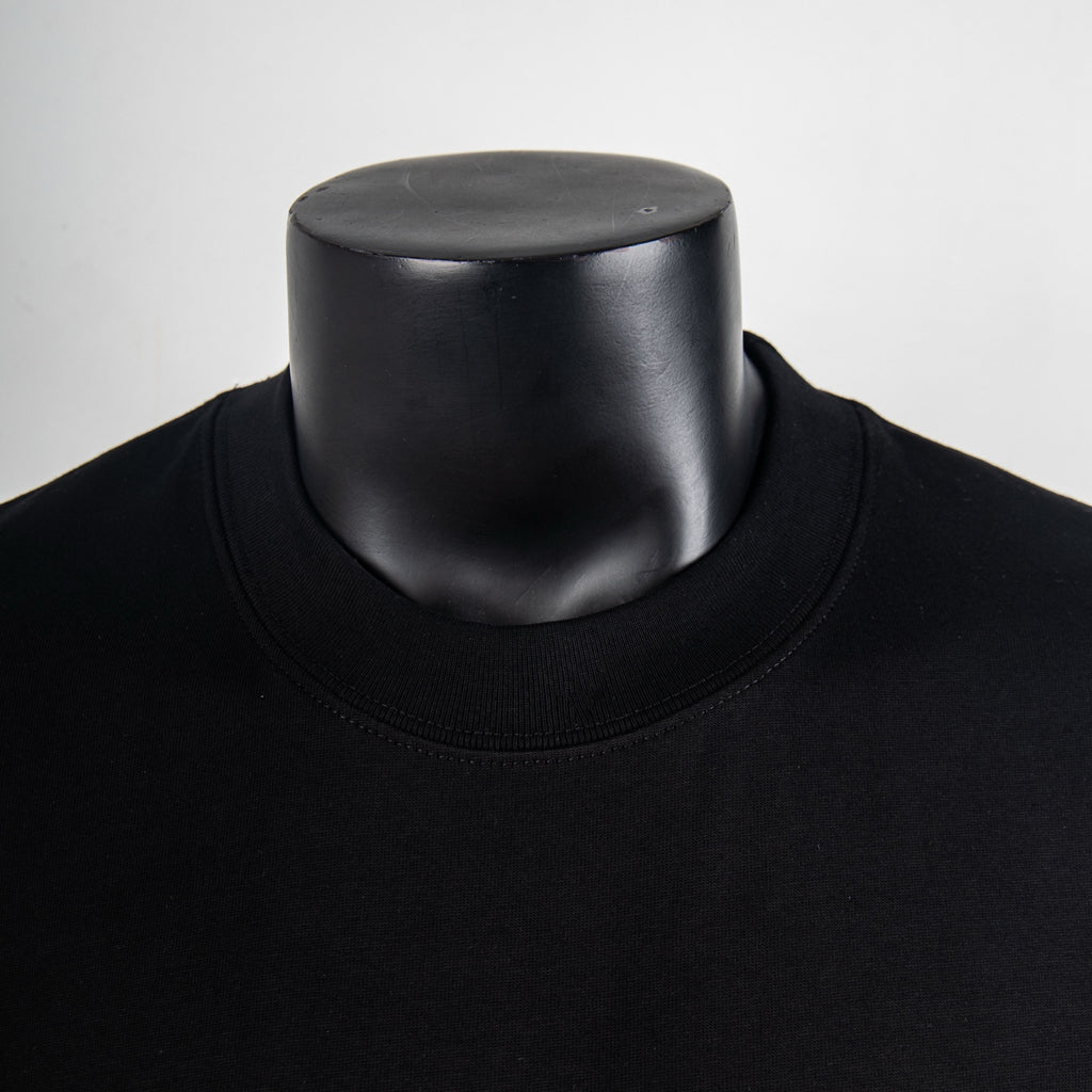 Black crew neck T-shirt collar close-up on a mannequin