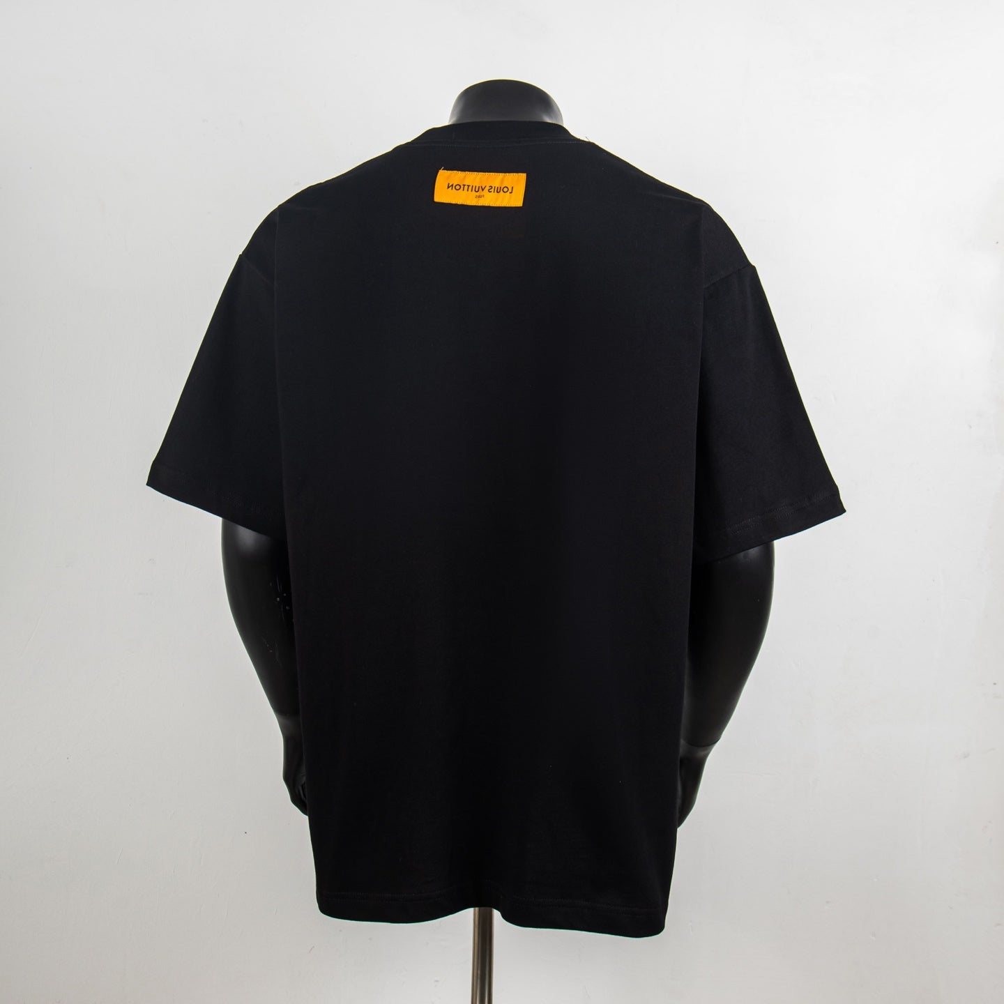 Black short-sleeve T-shirt with yellow back neck label