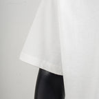 White T-shirt hem and sleeve edge detail with visible stitching