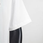 White T-shirt sleeve and curved hem with visible stitching
