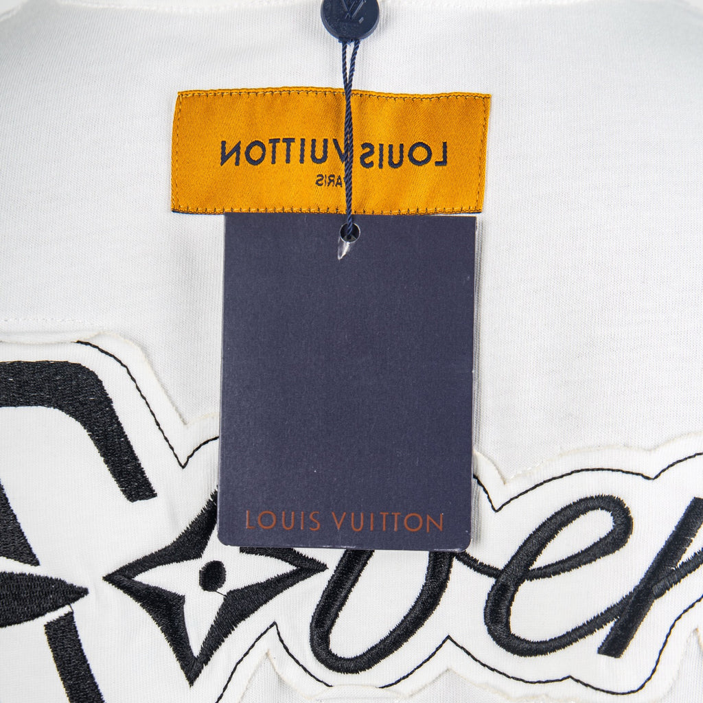Neck label and price tag area on white T-shirt with Louis Vuitton branding
