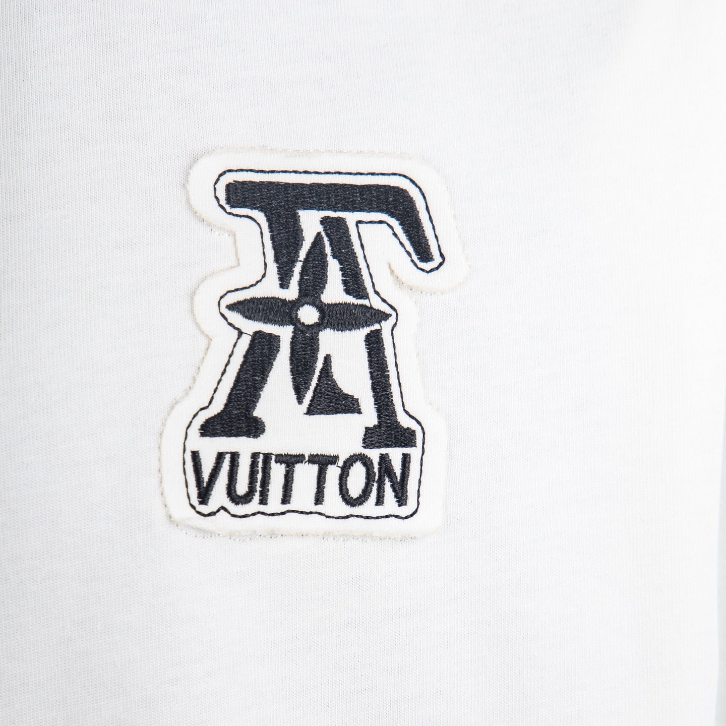 LV logo patch on white crew-neck T-shirt chest