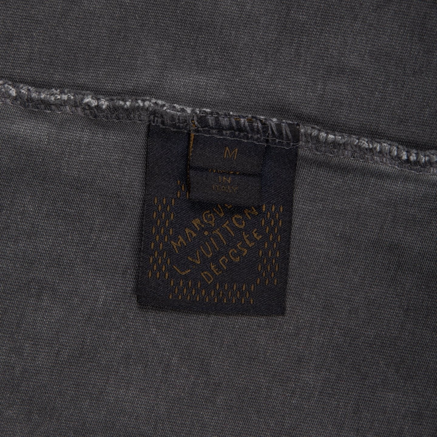 Louis Vuitton inner size label on dark gray T-shirt hem.