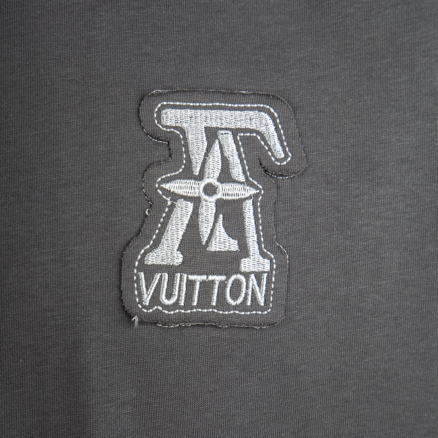 Louis Vuitton chest logo patch on dark gray short-sleeve T-shirt.