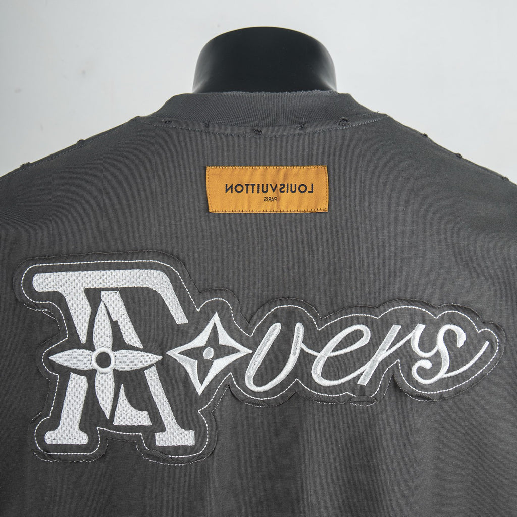 Louis Vuitton back graphic and tag on dark gray short-sleeve T-shirt.