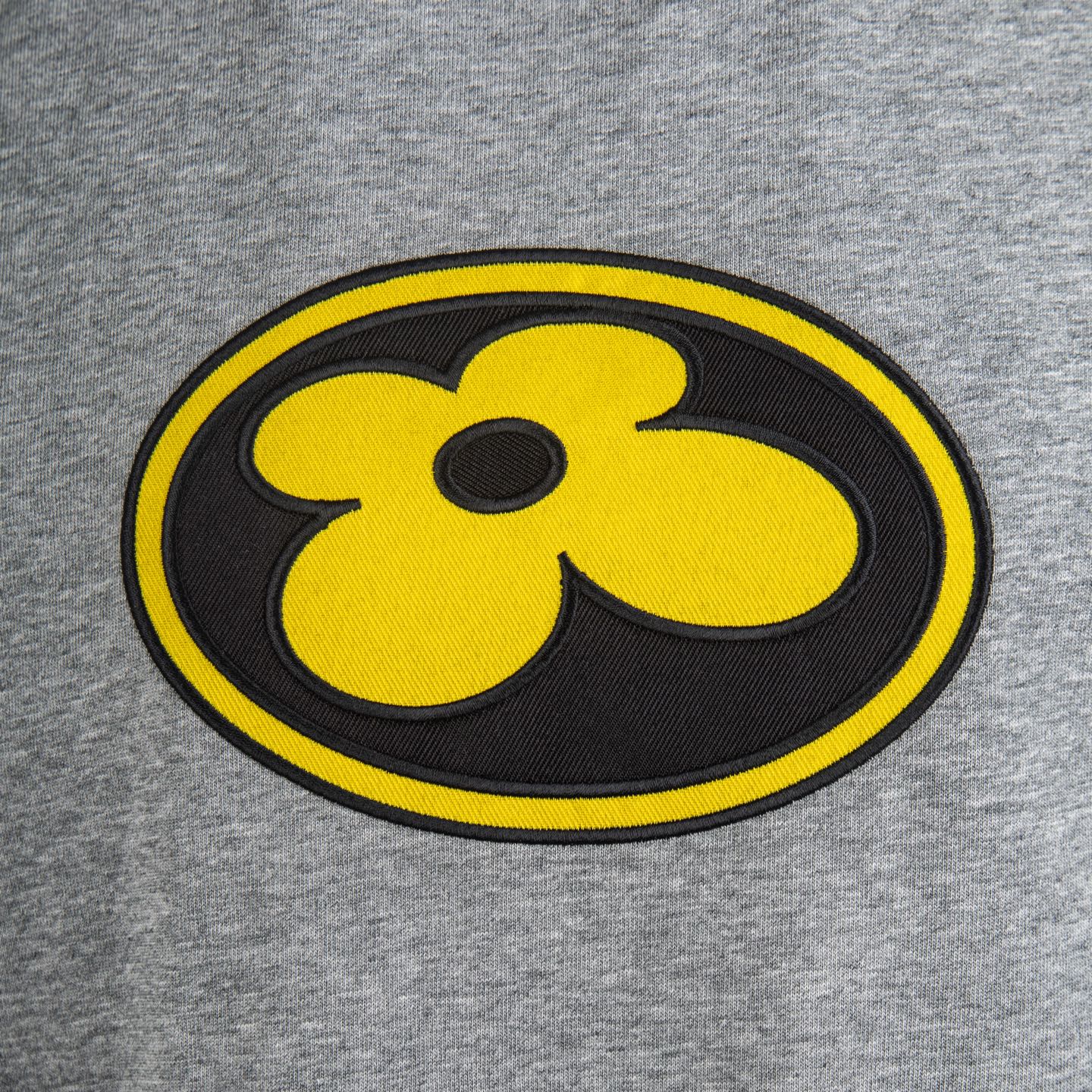 Heather gray T-shirt with large yellow and black flower emblem