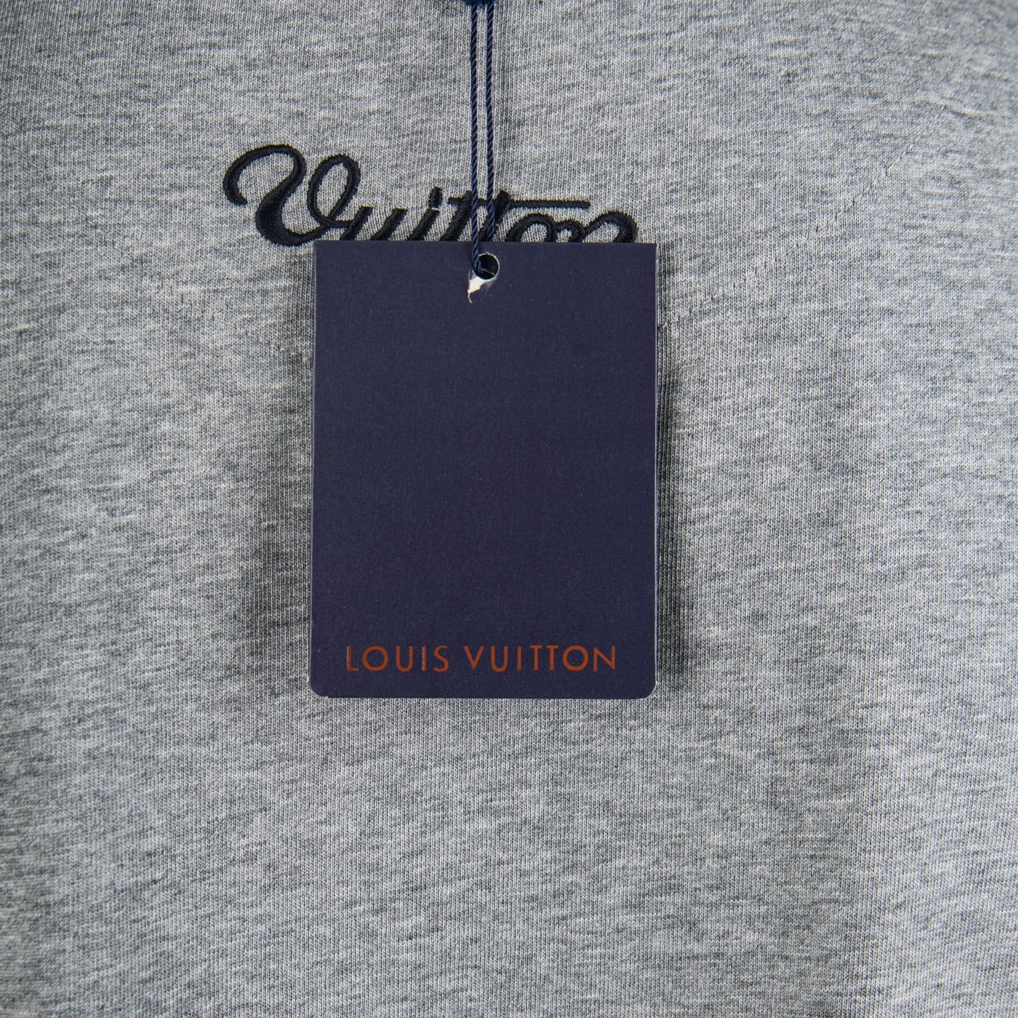 Louis Vuitton T-shirt with navy brand tag attached at chest