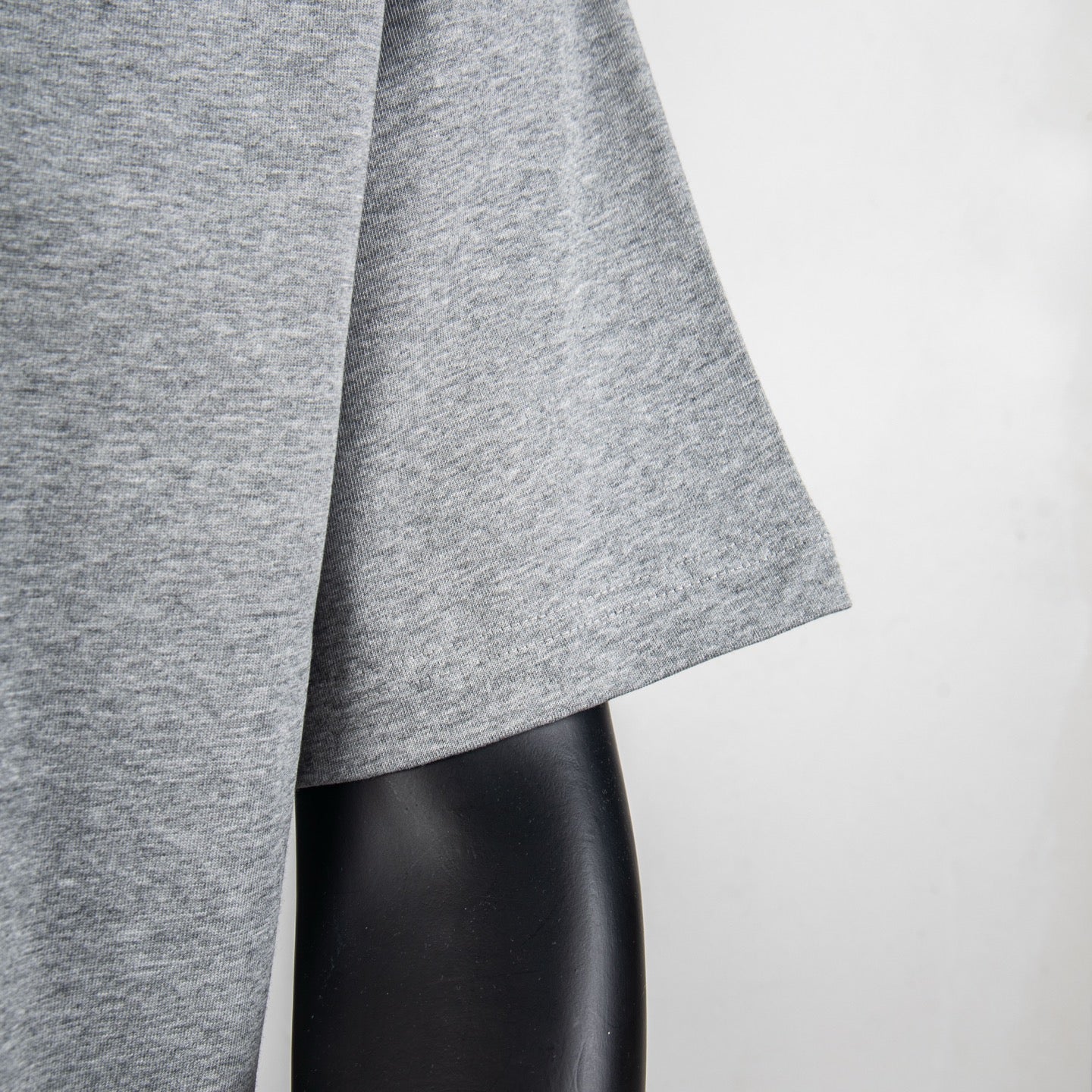 Heather gray T-shirt sleeve hem detail on a mannequin