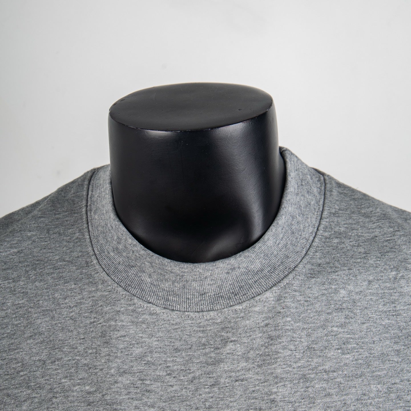 Heather gray crewneck T-shirt collar detail on a mannequin