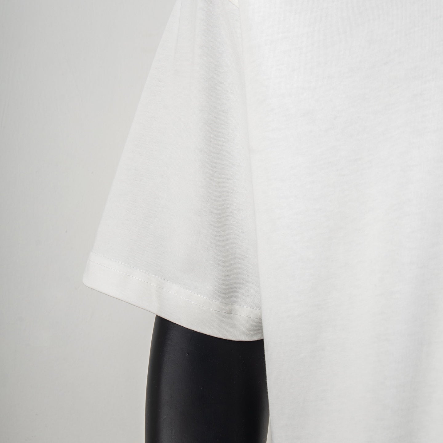 White short-sleeve T-shirt with straight hem and draped fabric