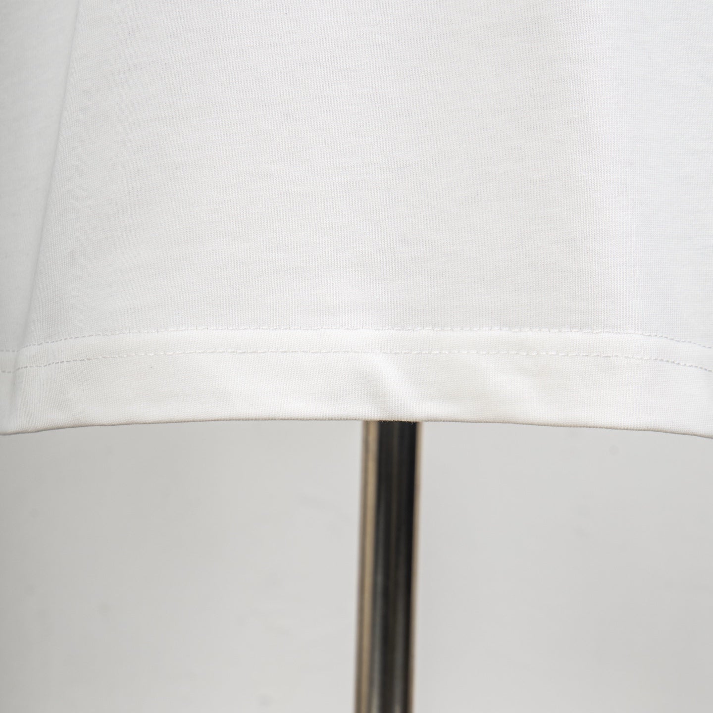 White T-shirt hem with stitched edge