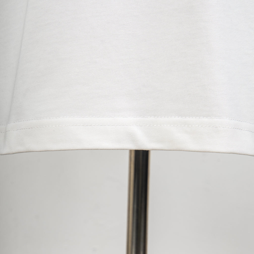White T-shirt bottom hem with visible stitching detail