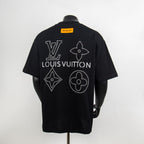 Black T-shirt back with large Louis Vuitton rhinestone symbols and yellow neck tag
